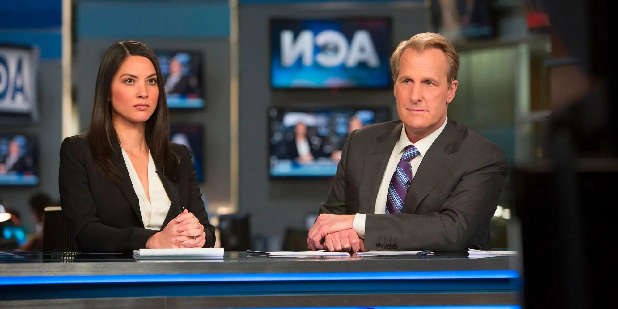 Will & Sloan Sitting At The News Desk In The Newsroom Image