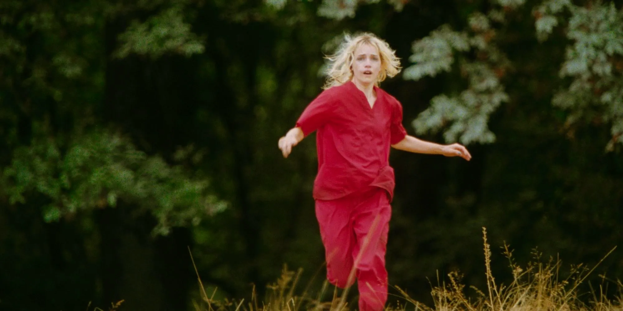 Willa Fitzgerald as The Lady running through the woods in Strange Darling Image