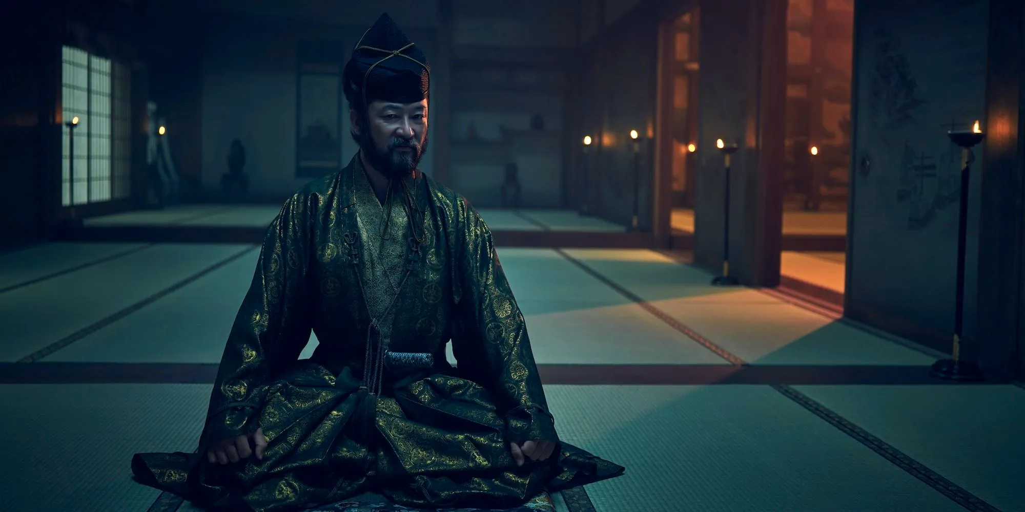 Yabushige sits on the floor with his head turned in Shogun Image