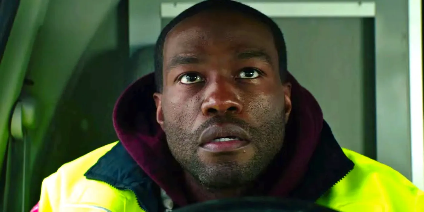 Yahya Abdul-Mateen II leaning forward over the driver's wheel in Ambulance Image