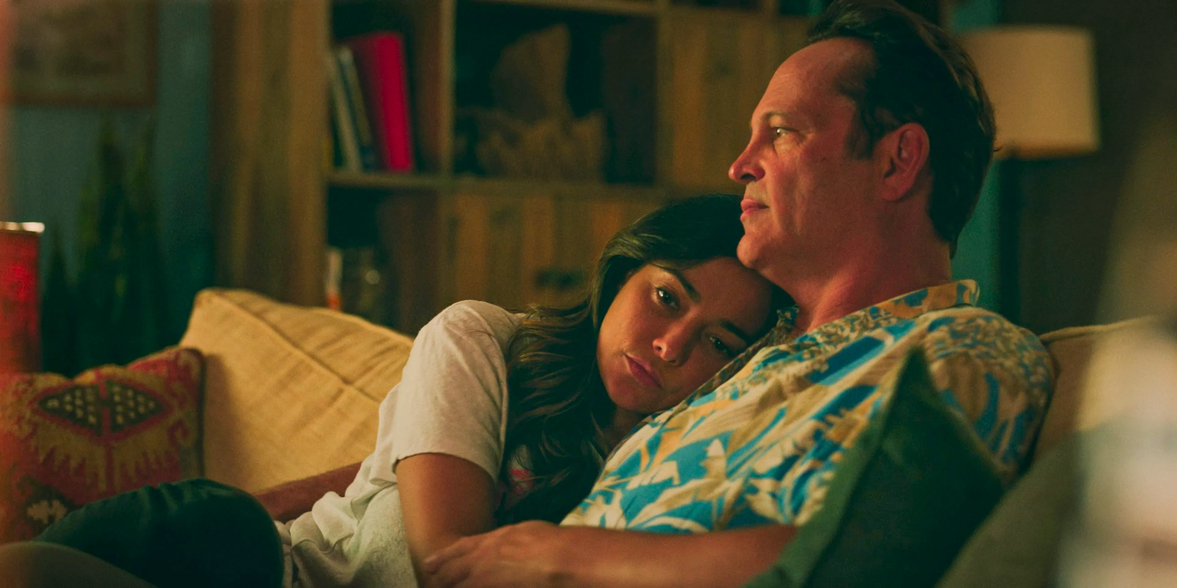 Yancy (Vince Vaughn) and Rosa (Natalie Martinez) cuddling on the sofa in Bad Monkey Season 1 Episode 7 Image