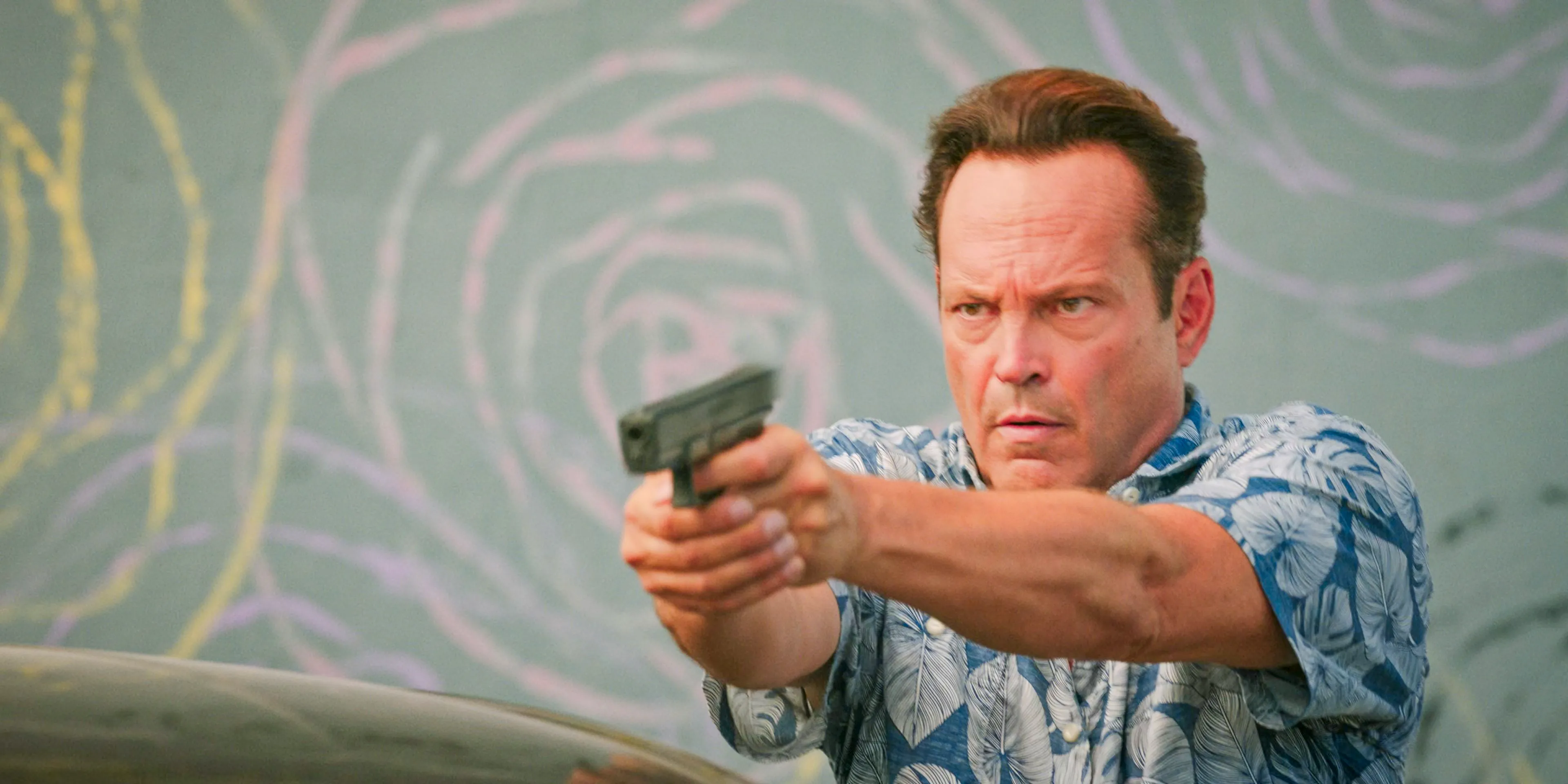 Yancy (Vince Vaughn) pointing a gun at Mendez in Bad Monkey Season 1 Episode 7 Image