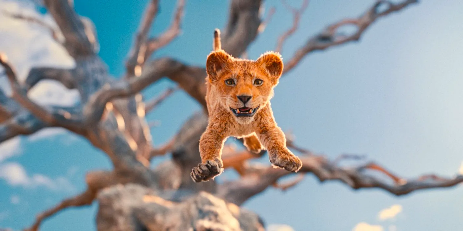 Young Mufasa leaps from the top of a tree in Mufasa: The Lion King Image