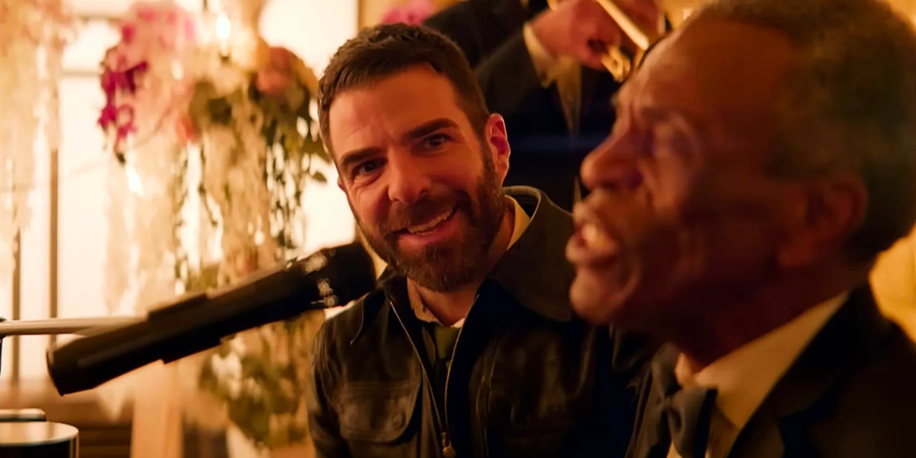 Zachary Quinto smiles as a patient sings in Brilliant Minds Image